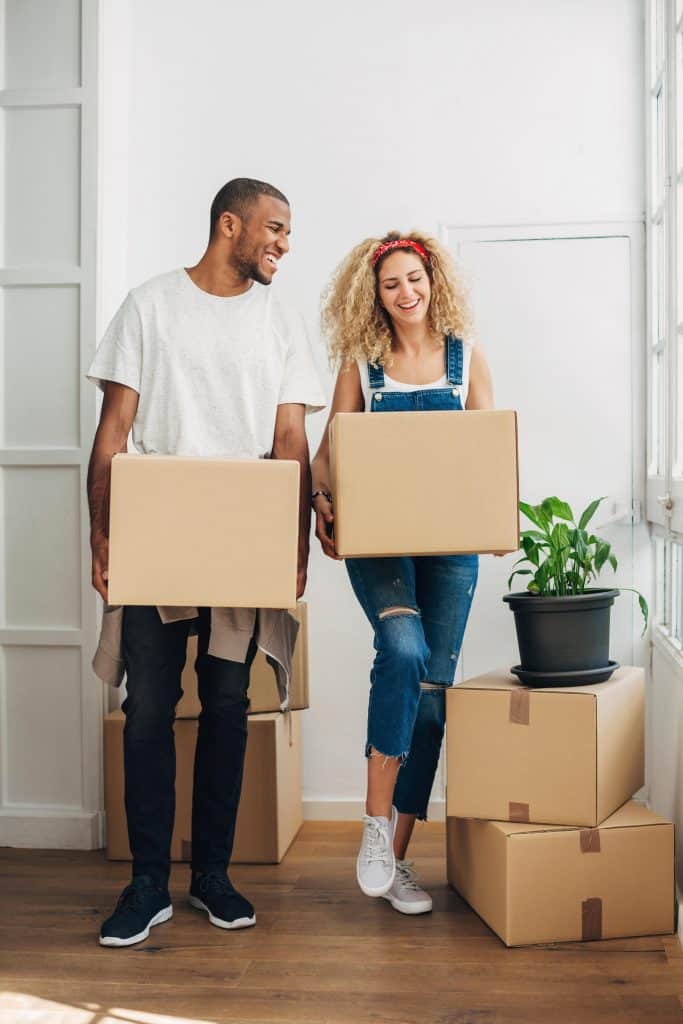 Customers of World Cargo, the international moving company, holding boxes for household shipping.